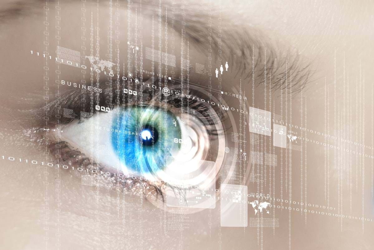 A close up of a woman's eye with a graphical overlay of binary and continents